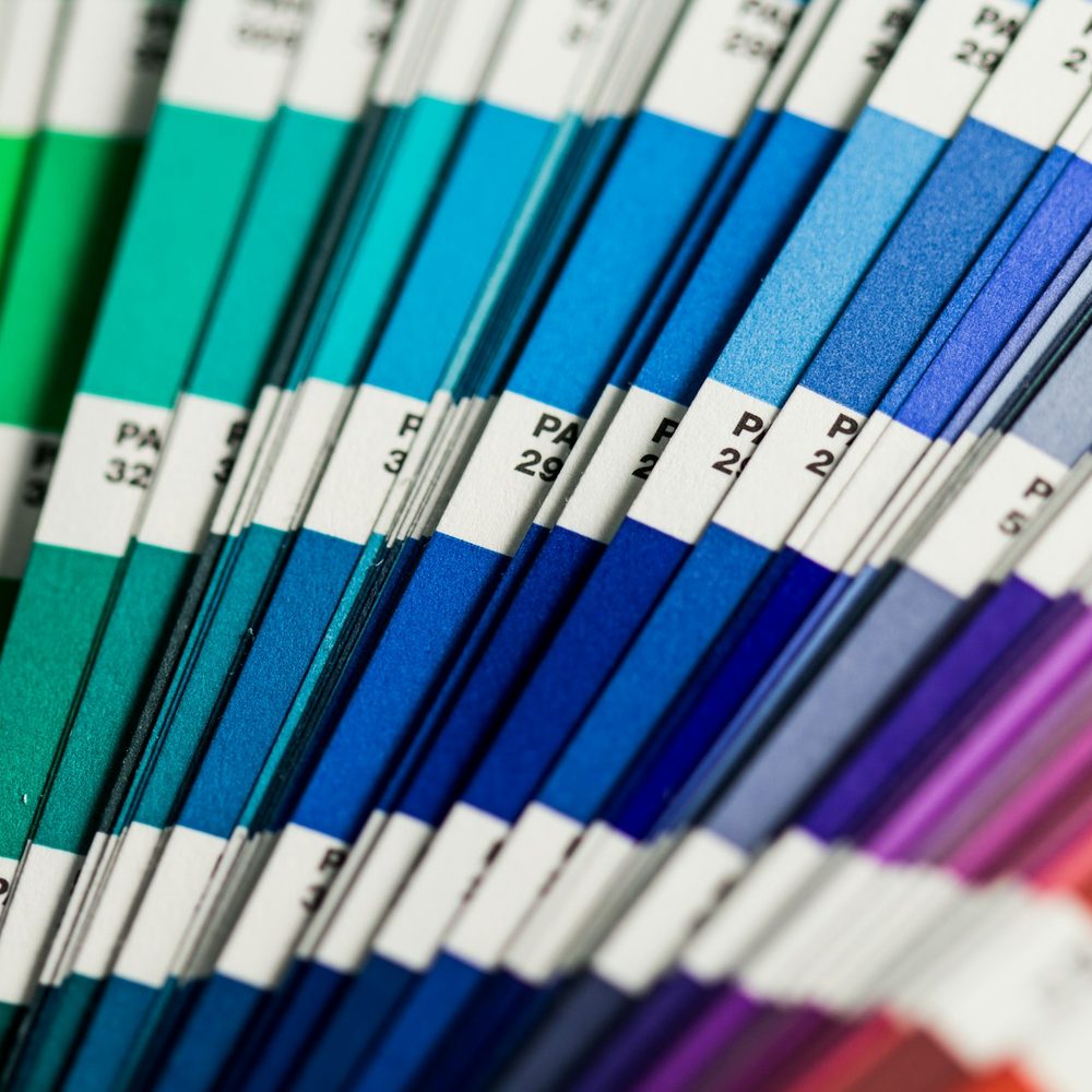 Fan of blue and green paint colour swatches
