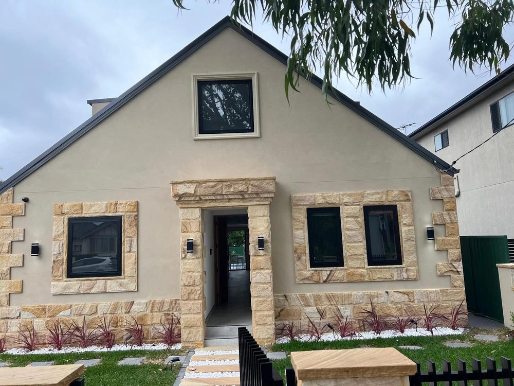 Rendered cottage with sandstone details after repainting